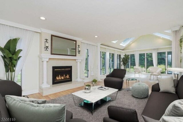 living room featuring vaulted ceiling with skylight and wood-type flooring