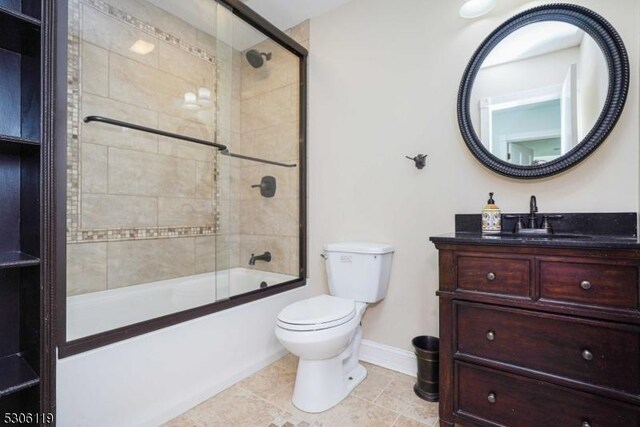 full bathroom featuring enclosed tub / shower combo, toilet, tile patterned floors, and vanity