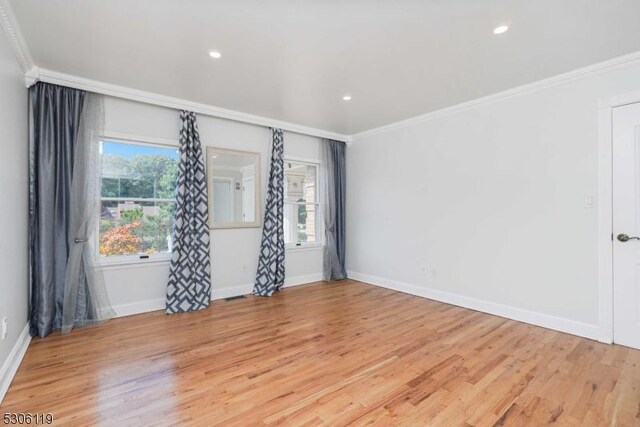 unfurnished room featuring light wood-type flooring and ornamental molding