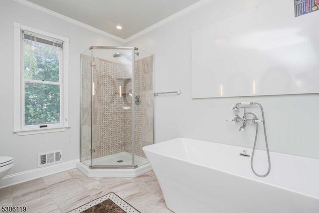 bathroom featuring toilet, plus walk in shower, tile patterned flooring, and a healthy amount of sunlight