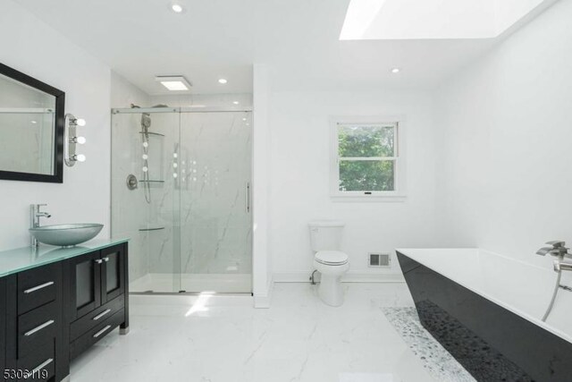 bathroom with a shower with door, toilet, vanity, and tile patterned flooring