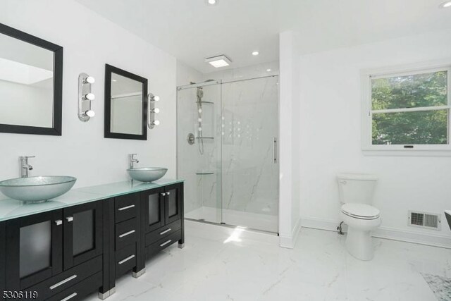 bathroom with double sink vanity, walk in shower, toilet, and tile patterned flooring