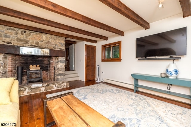 living room featuring wood-type flooring, beam ceiling, a wood stove, and a baseboard radiator