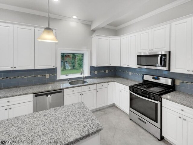 kitchen featuring appliances with stainless steel finishes, ornamental molding, sink, and decorative backsplash