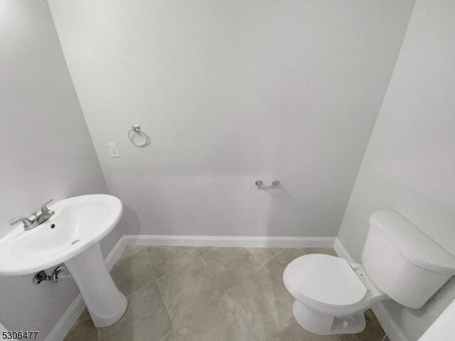 bathroom featuring toilet and tile patterned floors