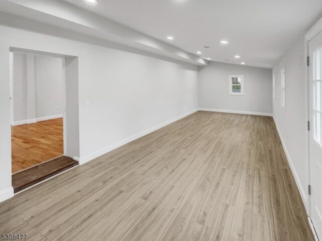 basement with light hardwood / wood-style floors