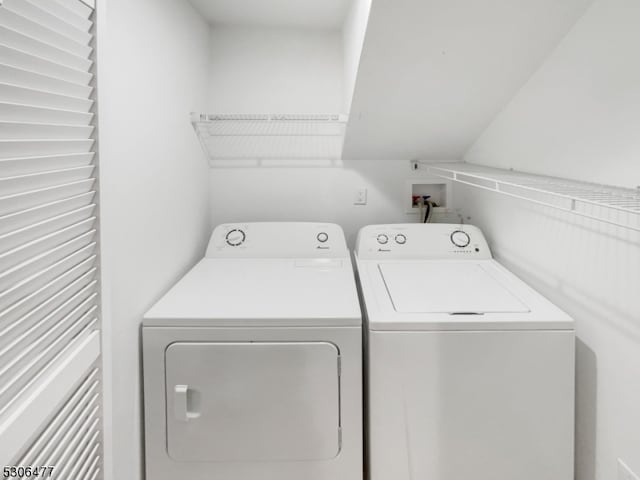 clothes washing area featuring washing machine and clothes dryer