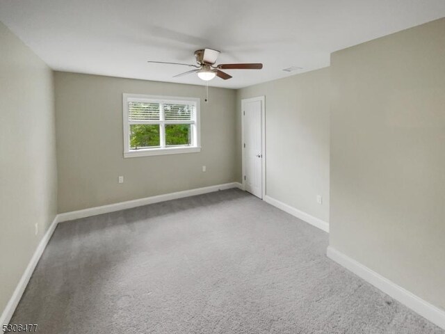 empty room with ceiling fan and carpet flooring