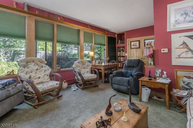 living room featuring plenty of natural light and carpet flooring