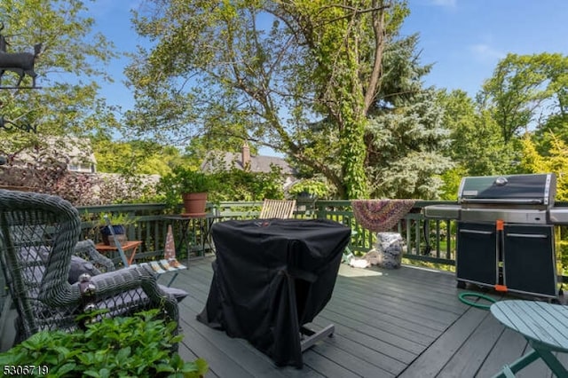 wooden terrace featuring a grill