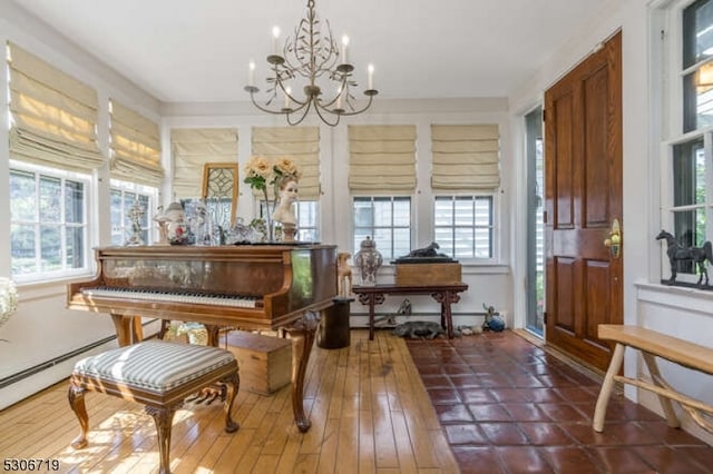 miscellaneous room featuring a notable chandelier, hardwood / wood-style floors, and a baseboard radiator