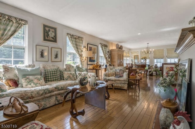 living room featuring hardwood / wood-style flooring and an inviting chandelier