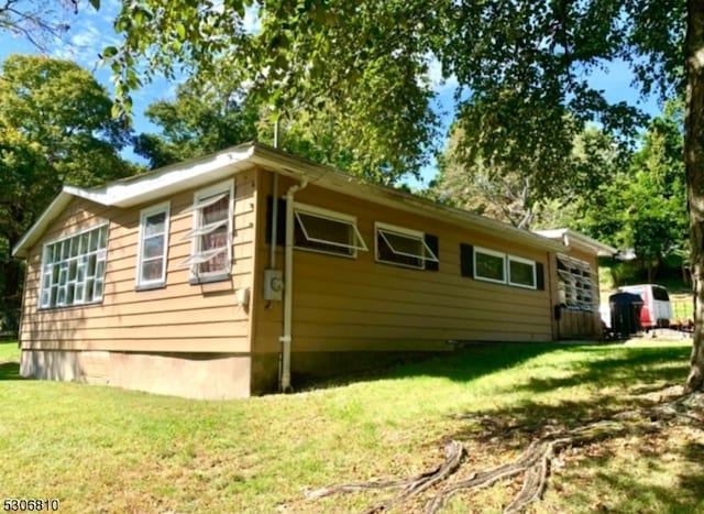 view of property exterior with a yard