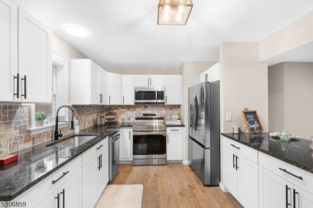 kitchen featuring light hardwood / wood-style flooring, stainless steel appliances, white cabinetry, and sink