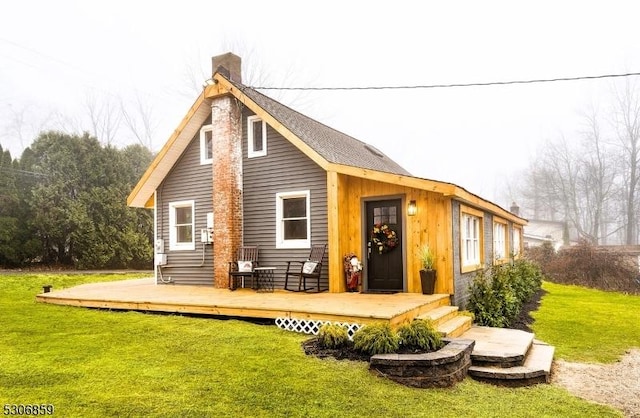 rear view of property featuring a yard