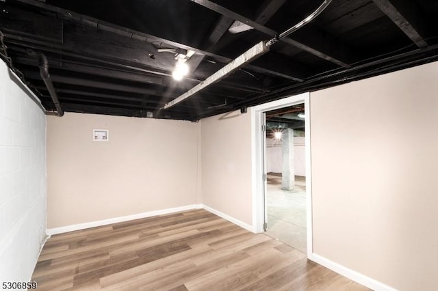 basement with hardwood / wood-style flooring