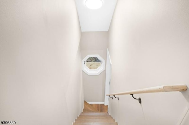 stairs featuring hardwood / wood-style flooring