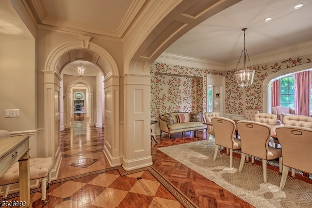 dining area featuring a notable chandelier, decorative columns, parquet flooring, and crown molding