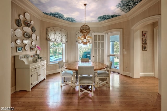 dining area featuring light hardwood / wood-style flooring, a chandelier, and crown molding