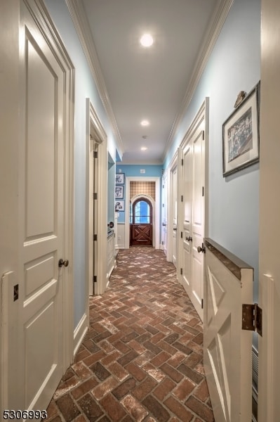 corridor featuring crown molding