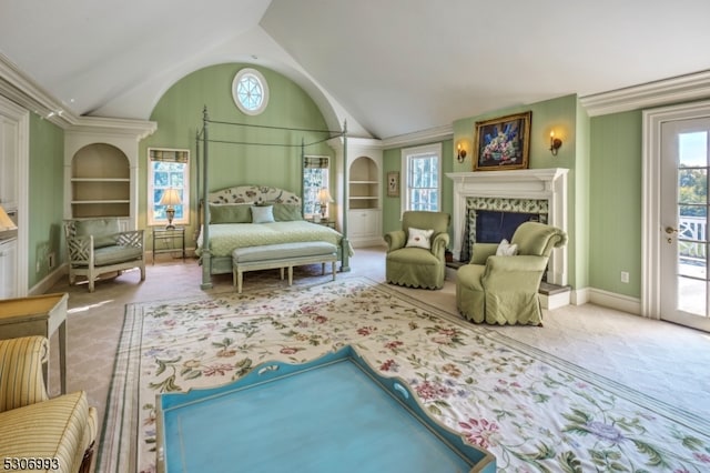 bedroom featuring carpet flooring, vaulted ceiling, a premium fireplace, and access to exterior