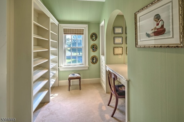 carpeted office with vaulted ceiling