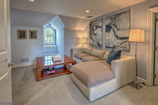 carpeted living room with vaulted ceiling