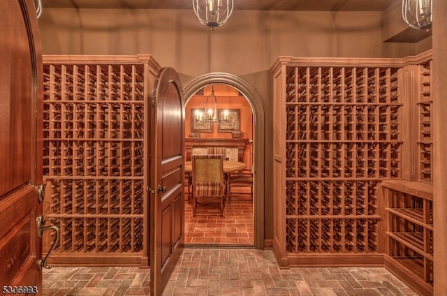 wine area featuring an inviting chandelier