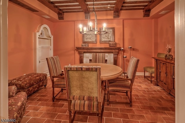 tiled dining area featuring a chandelier and beamed ceiling