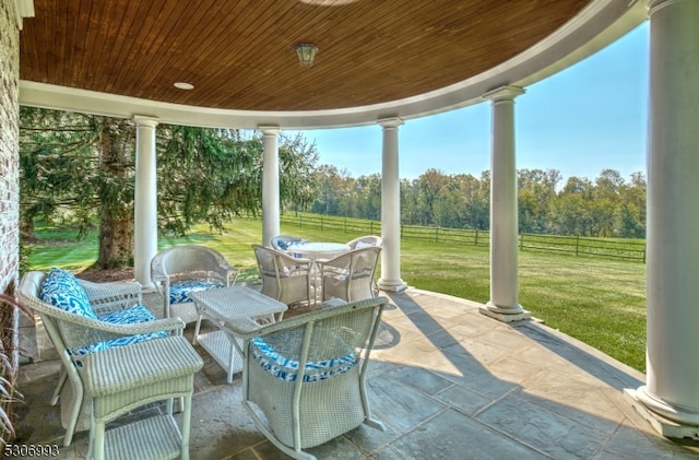 sunroom featuring wooden ceiling and ornate columns