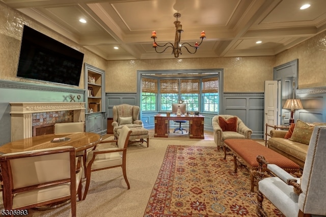 living area featuring beam ceiling, a fireplace, coffered ceiling, and a chandelier