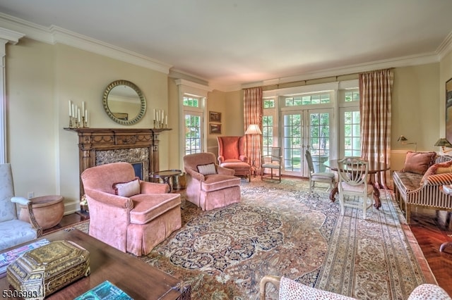 living room featuring crown molding, a fireplace, and french doors