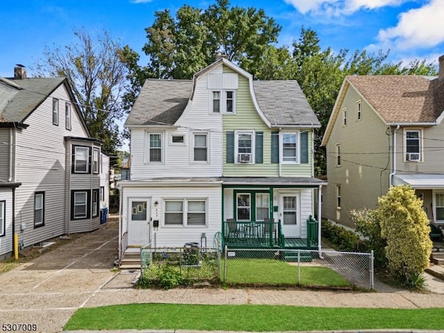 view of front of house featuring a fenced front yard, a porch, and a gate