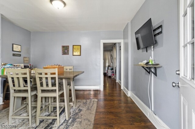 dining room featuring wood finished floors and baseboards