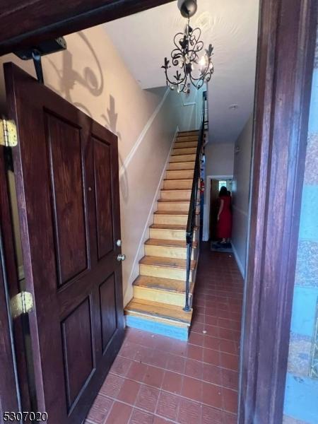 entryway with a chandelier