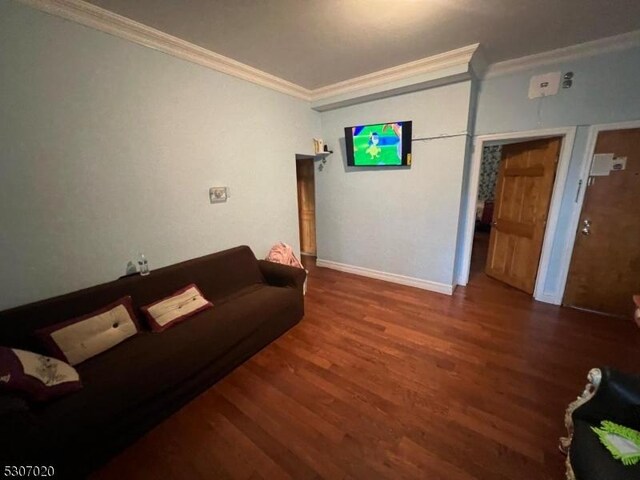 living room with crown molding and hardwood / wood-style floors