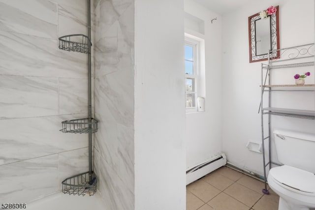 bathroom featuring toilet, a baseboard heating unit, and tile patterned floors