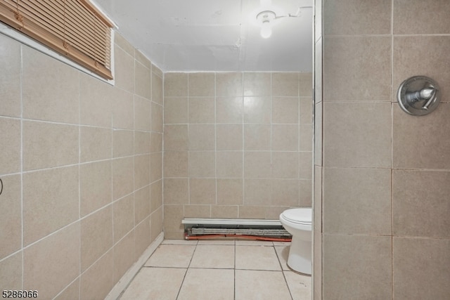 bathroom featuring toilet, walk in shower, tile patterned floors, and tile walls