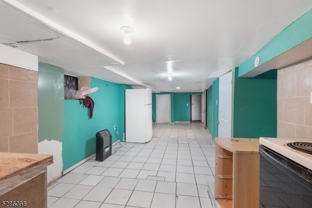 interior space with light tile patterned floors and white refrigerator