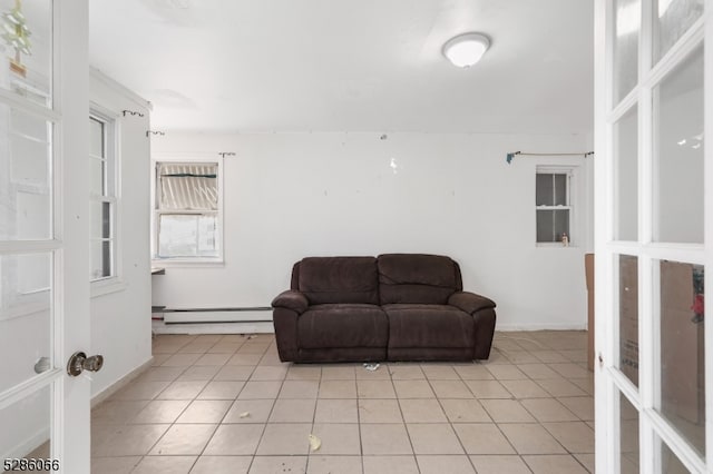 living area featuring light tile patterned floors and a baseboard radiator