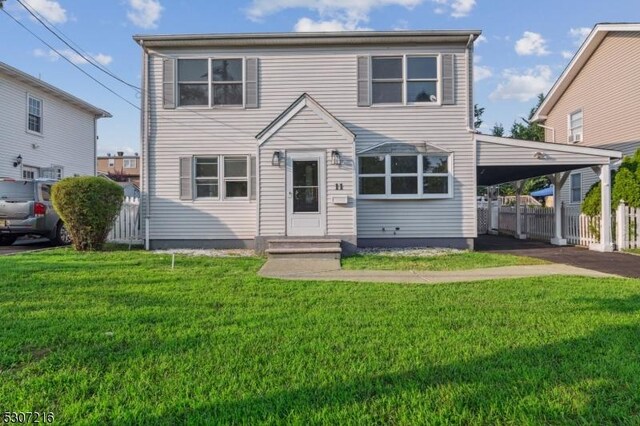 front of property featuring a front lawn and a carport