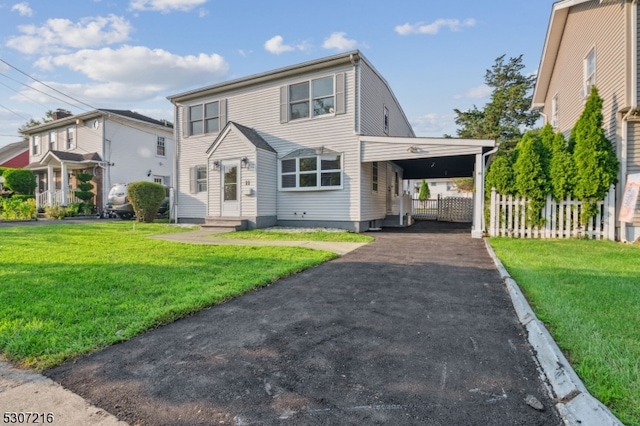 view of front of house with a front lawn and a carport