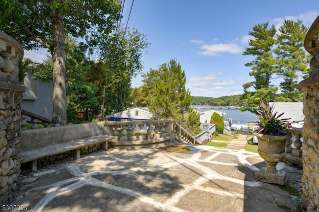 view of patio with a water view