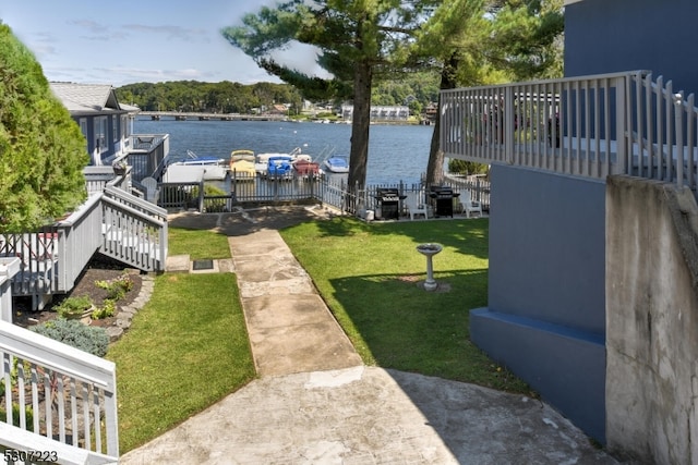 view of yard with a deck with water view