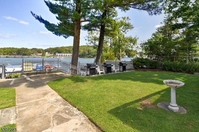 view of yard featuring a water view and fence