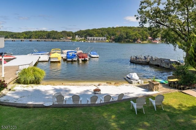 dock area with a water view and a lawn