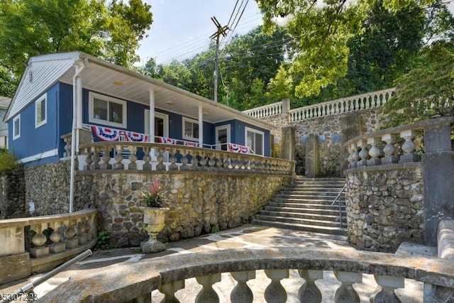 view of front of property with stairway