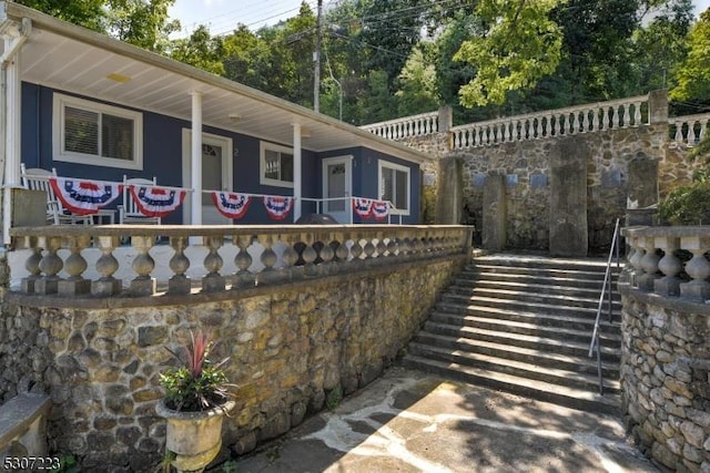 view of side of home featuring stairway