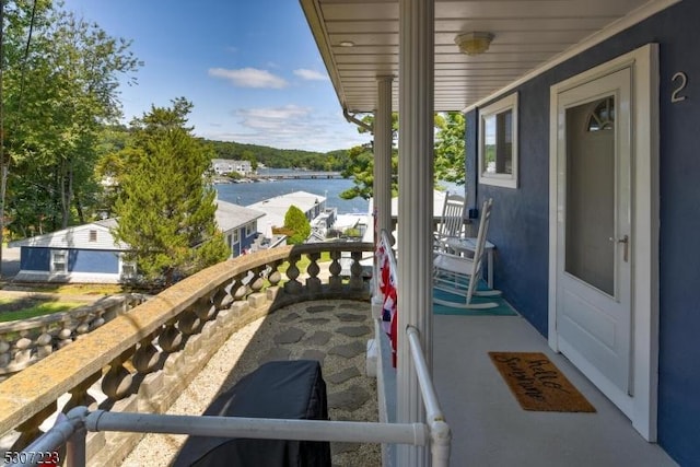 balcony featuring a water view