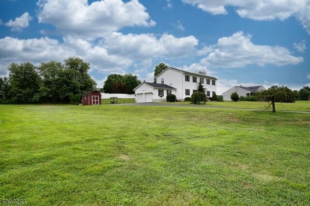 view of yard with a storage shed and a garage